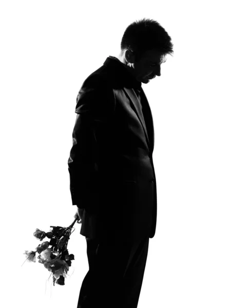 Silhouette man offering flowers — Stock Photo, Image