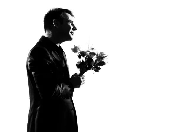 Silhouette man offering flowers — Stock Photo, Image