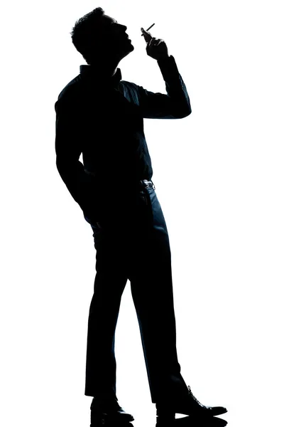 Silhouette man smoking cigarette full length — Stock Photo, Image