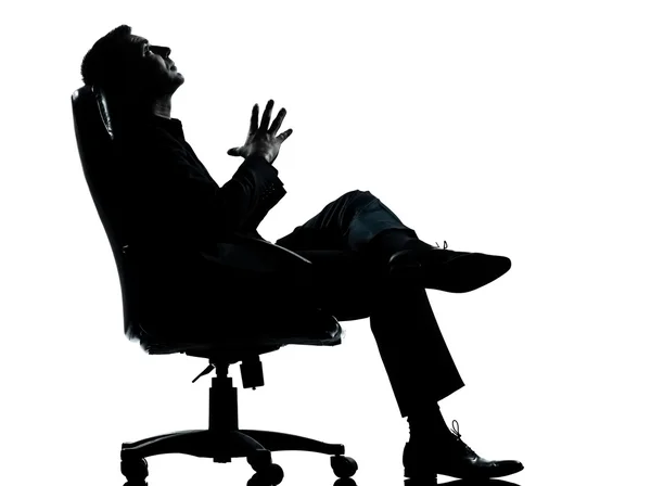 Een zakenman zitten in een leunstoel ontspannen denken silhouett — Stockfoto