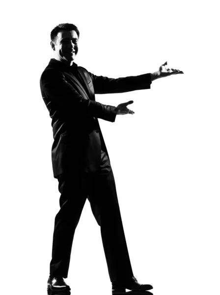 Homem silhueta mostrando gesto introduzindo apresentação — Fotografia de Stock
