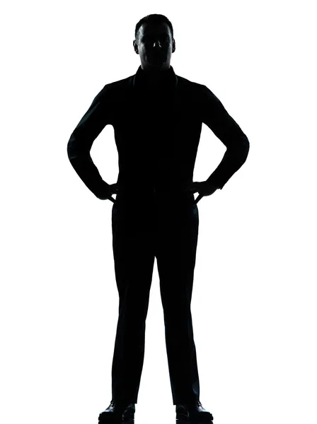 Bir iş adamı ayakta eller kalça siluet — Stok fotoğraf