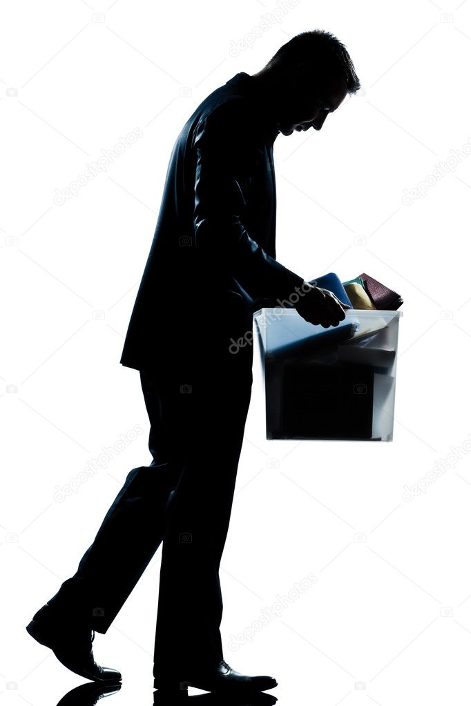 Silhouette man fired carrying heavy box