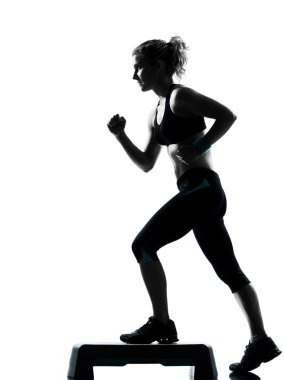 Woman exercising step aerobics clipart