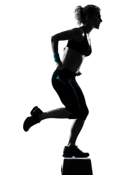 Woman exercising step aerobics — Stock Photo, Image