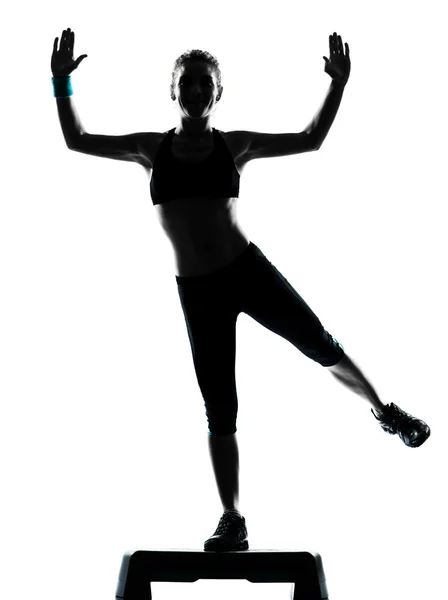 Woman exercising step aerobics — Stock Photo, Image