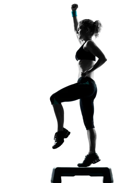 Woman exercising step aerobics — Stock Photo, Image