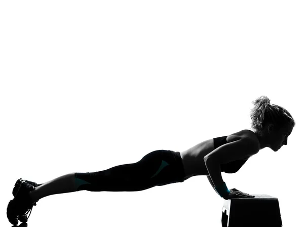 Woman exercising step aerobics Stock Photo