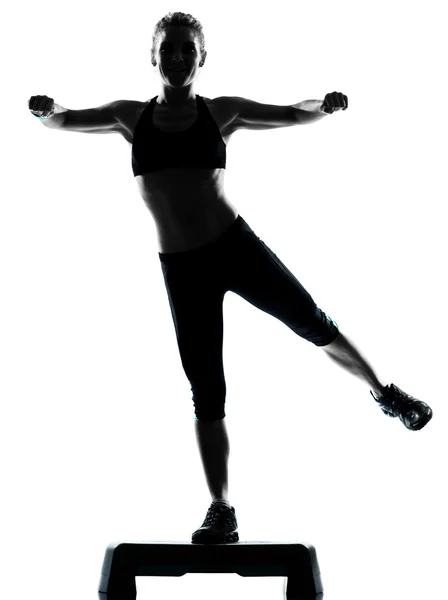 Kvinna utövar steg aerobics Stockbild