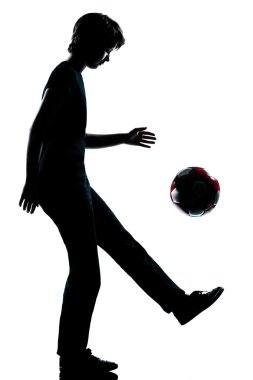 One young teenager boy or girl silhouette juggling soccer footba clipart