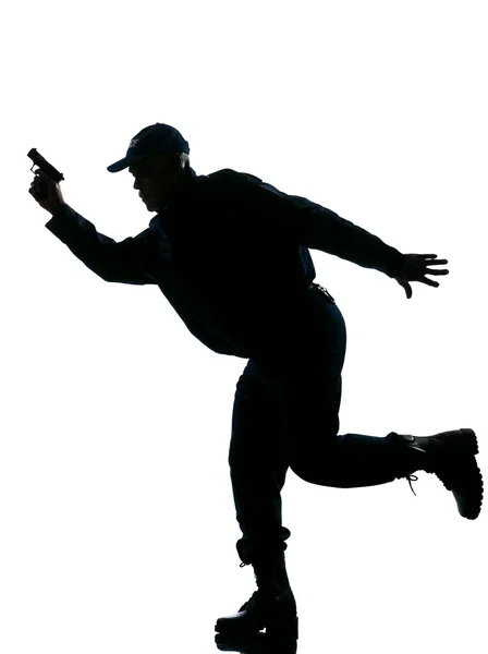 Silhouette Polizeimann läuft mit Handfeuerwaffe — Stockfoto