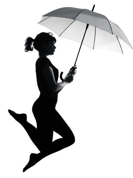 Silhouette woman flying holding open umbrella — Stock Photo, Image