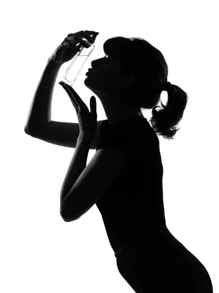 Silhouette woman kissing her perfume — Stock Photo, Image