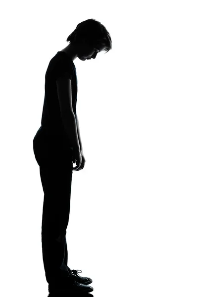 stock image One young teenager boy or girl sad looking down silhouette