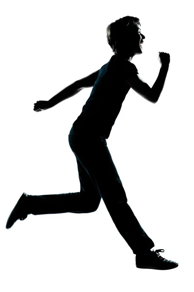Uma jovem adolescente menino menina correndo rindo silhueta — Fotografia de Stock