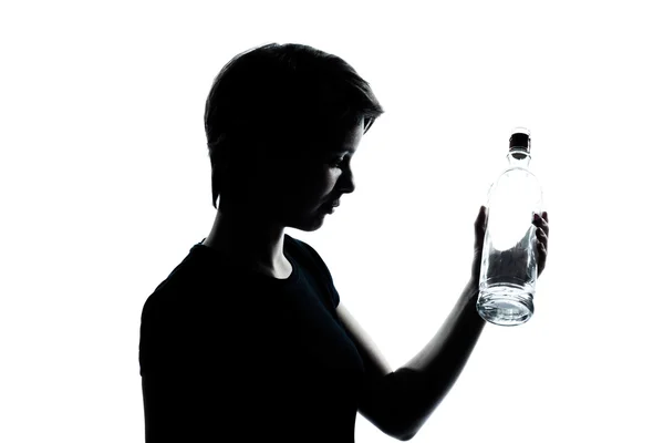 Um jovem adolescente menino ou menina segurando vazia garrafa de álcool vodka — Fotografia de Stock