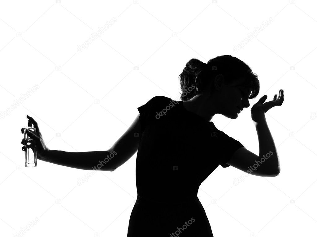 Silhouette woman smelling perfume
