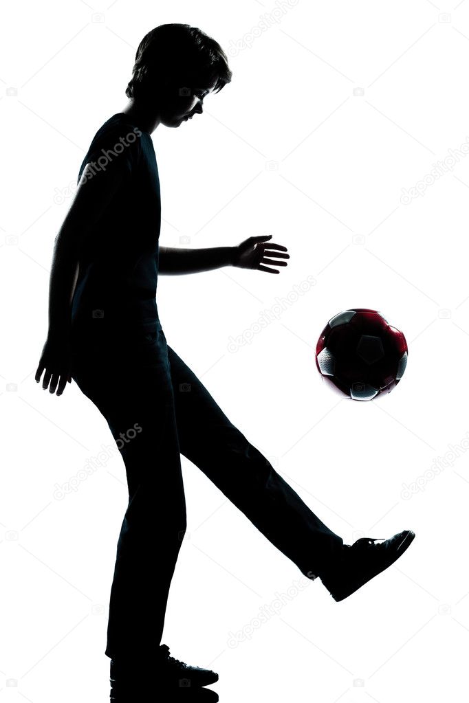 One young teenager boy or girl silhouette juggling soccer footba