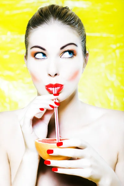 Woman drinking grapefruit juice — Stock Photo, Image