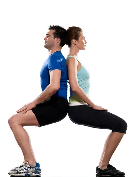 Couple doing workout back to back — Stock Photo, Image