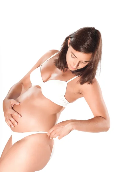 Mulher grávida examinando seus quadris — Fotografia de Stock