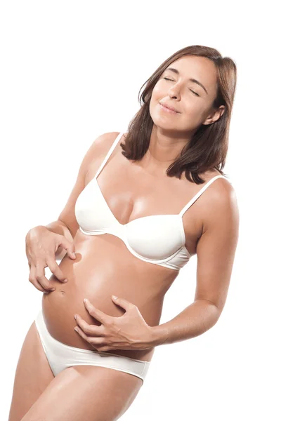 Беременная женщина чешется — стоковое фото