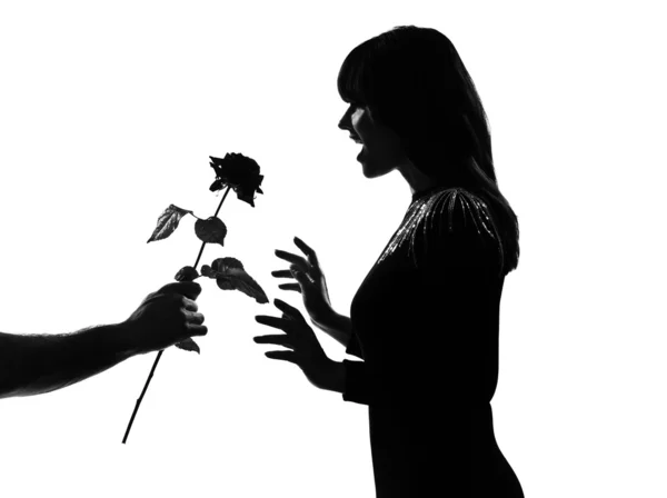 Silhouette man hand offering a flower rose — Stock Photo, Image