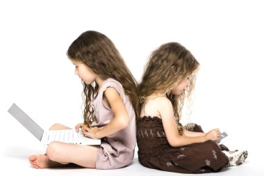 Little girls playing game console back to back clipart