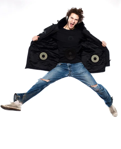Az ember hallgat zenét, sikoltozva, boldog jumping Jogdíjmentes Stock Fotók
