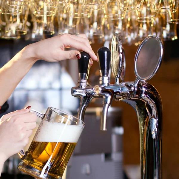 Waiting woman pouring beer Royalty Free Stock Images