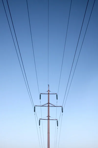 Symmetric electrical lines on mast — Stock Photo, Image