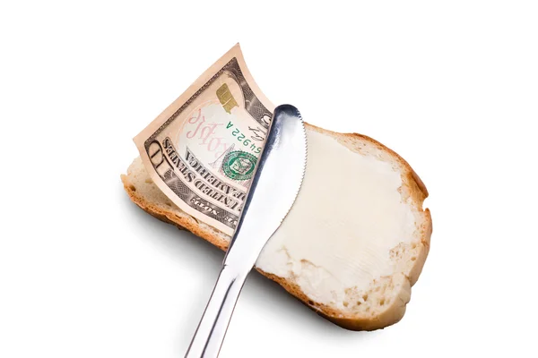 Масло и деньги на куске хлеба — стоковое фото