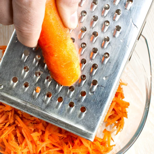 Stock image The hand with carrot rubs