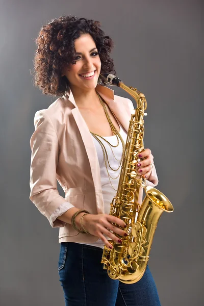 stock image Beautiful Girl with Saxophone on Grey Background