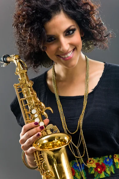 Stock image Beautiful Girl with Saxophone on Grey Background