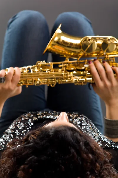 stock image Beautiful Girl with Saxophone on Grey Background