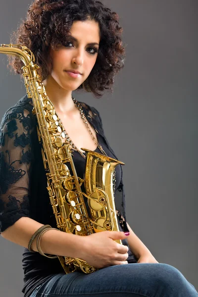 stock image Beautiful Girl with Saxophone on Grey Background