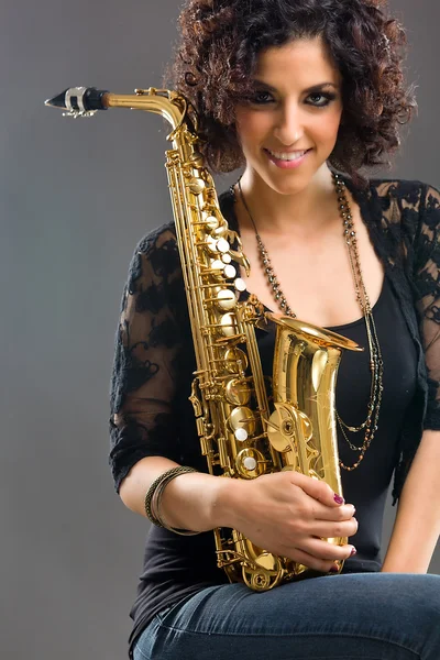 stock image Beautiful Girl with Saxophone on Grey Background