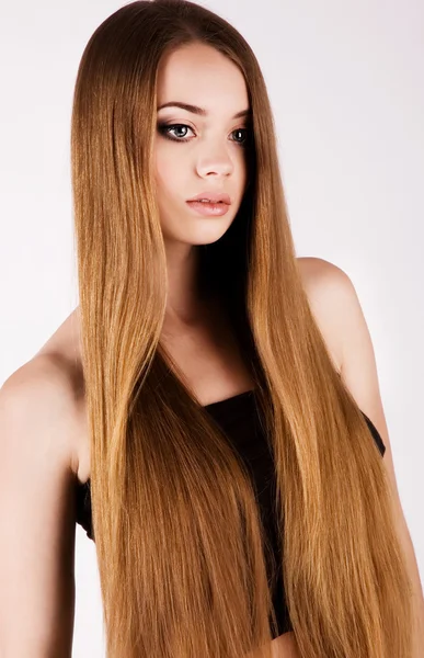 A beautiful young girl with long hair — Stock Photo, Image