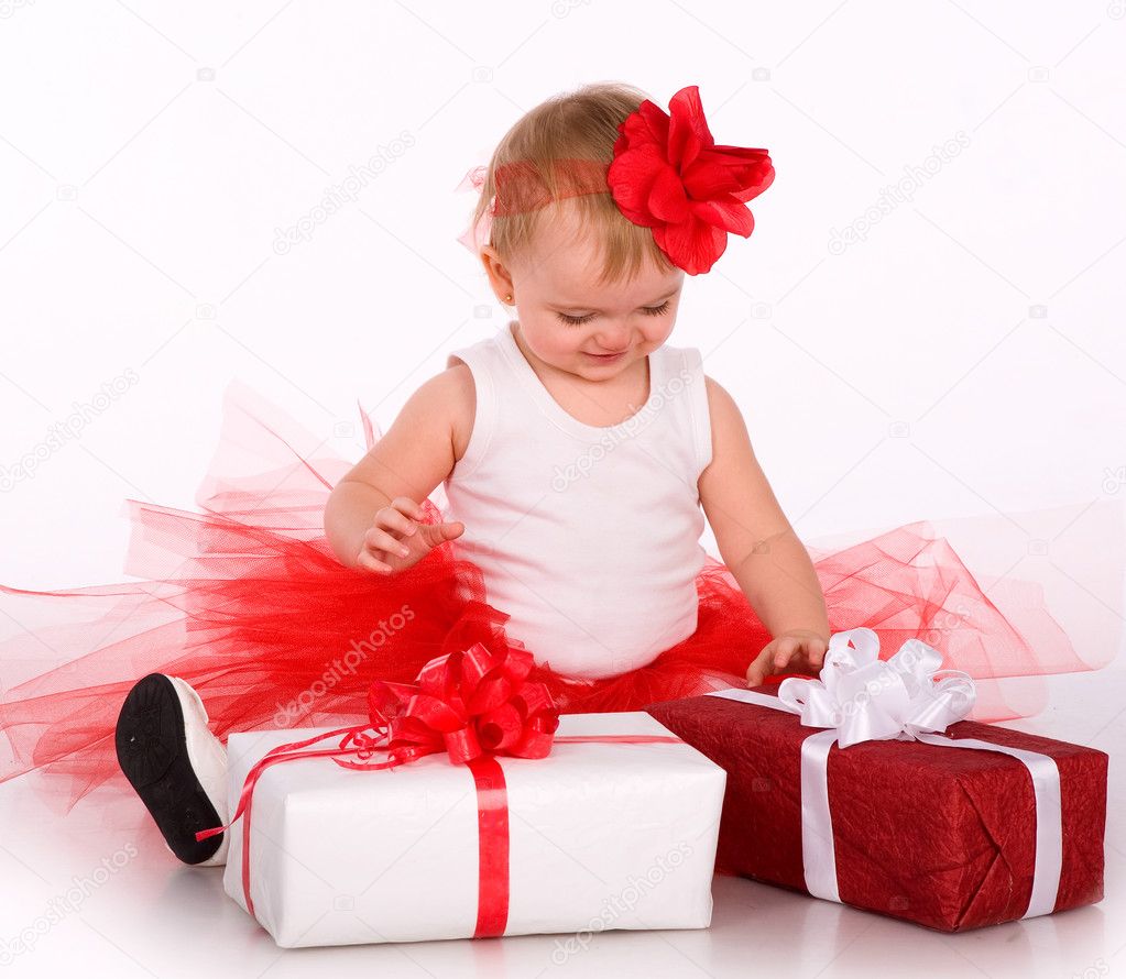 Cute baby playing with a toy and gift