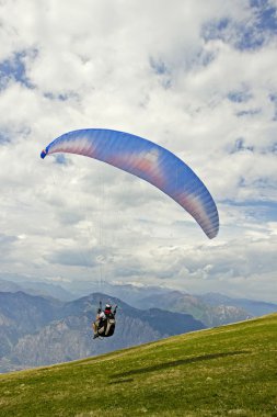 Paragliding on the mountain clipart