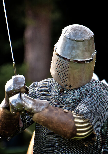 Knight with raised sward, face covered