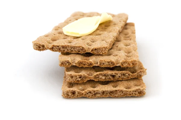 Brauner Cracker und Butter auf weißem Hintergrund — Stockfoto