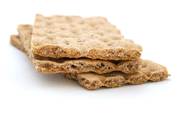 Tři hnědé cracker nad bílým pozadím, dieta — Stock fotografie