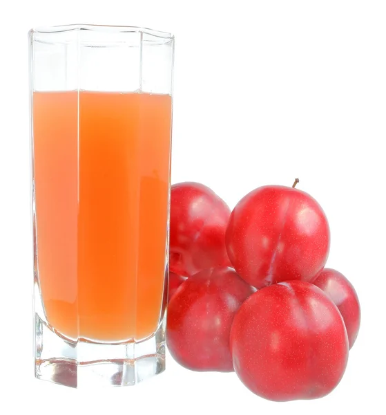 A glass of plum juice with heap of plum isolated — Stock Photo, Image