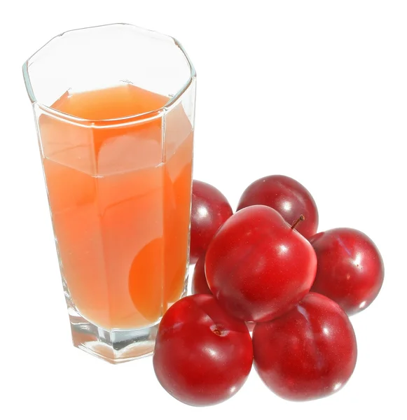 A glass of plum juice with heap of plum top view — Stock Photo, Image