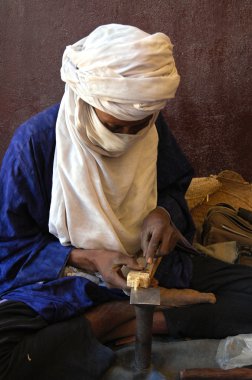 Artisan working on jewellry in Niger clipart