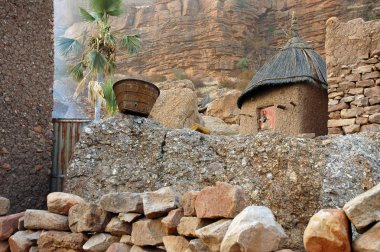 A traditional Dogon granary below cliff face clipart
