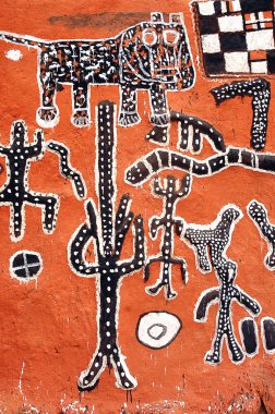 Vertical view of Dogon artwork on the side of a building clipart