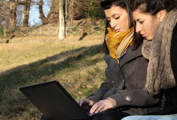 Young girls using laptop outdoor — Stock Photo, Image